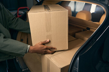 Male takes things out of a car in a storage service