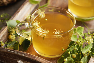 Herbal tea with fresh linden or Tilia cordata flowers harvested in spring