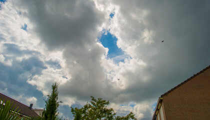 Dark and white clouds in a blue sky sky, Almere, Flevoland, The Netherlands, May 30, 2024