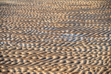 Close-up of sand pattern on the beach. Selective focus.