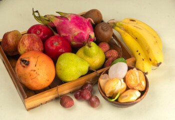 Assortment of fresh organic fruits and vegetables in basket on background, closeup.