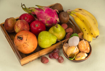 Assortment of fresh organic fruits and vegetables in basket on background, closeup.
