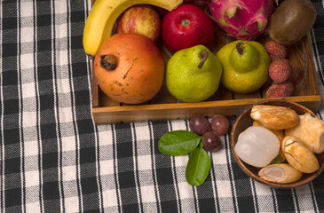 Assortment of fresh organic fruits and vegetables in basket on background, closeup.