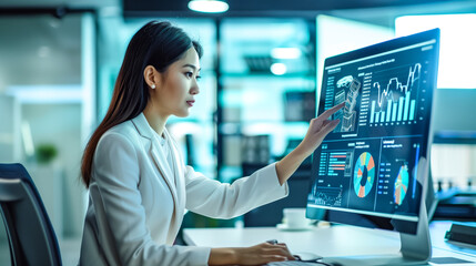 Chinese corporate woman interacting with a computer screen - Powered by Adobe