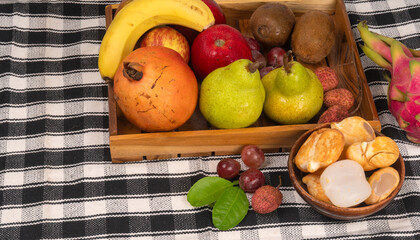 Assortment of fresh organic fruits and vegetables in basket on background, closeup.