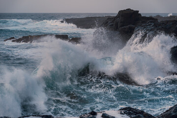 waves beating against the rocks in El Puertillo at sunset. Arucas. Gran Canaria. Canary islands