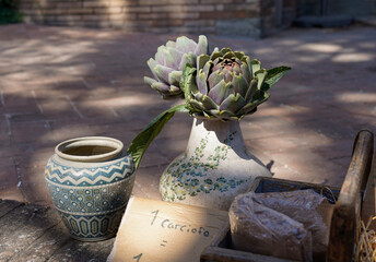 Artichoke in flower vase for sale on the street in Spello, Italy 