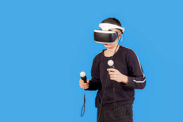 A guy in a VR helmet and with a joystick in his hands.