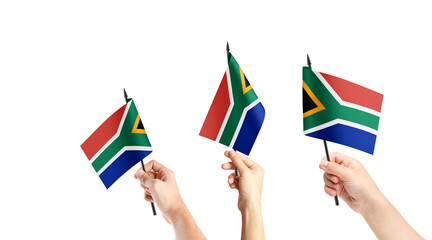 A group of people are holding small flags of South Africa in their hands.