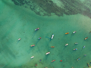 Aerial drone bird's eye view photo Top down of tropical sea with long tail fishing boats Travel boats at phuket thailand, Amazing top view sea nature landscape