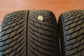 Car wheels, tires and wheels with a shiny disc in a car service center for seasonal replacement or...