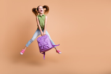 Photo of kid girl jump hold rucksack isolated pastel color background
