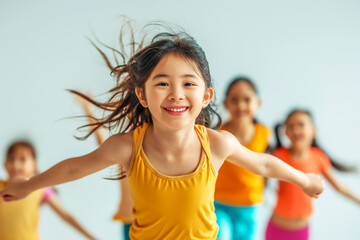 A cheerful young girl smiling as she runs with her friends during a gym class, all wearing bright, colorful outfits.
