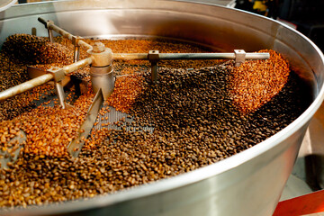 close-up of a coffee roasting factory inside drum roasting stirring coffee