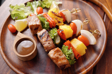 Barbecue grilled sliced ​​meat and vegetables on a wooden tableBarbecue grilled sliced ​​meat and vegetables on a wooden table