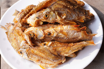 Crispy fried fish food In a white plate close-up