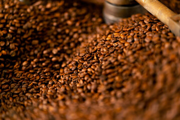 close-up of a coffee roasting factory inside drum roasting stirring coffee