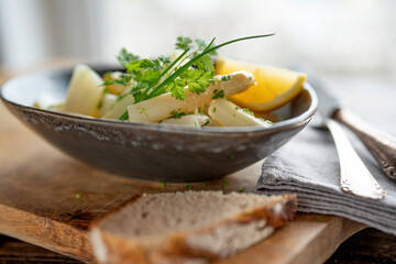Bowl of fresh salad with asparagus and herbs on rustik wood. Background for halthy nutrion and...