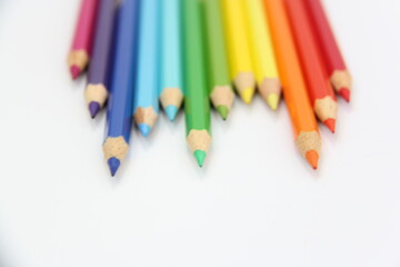 sharpener and colored pencils on a white background