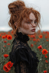 Naklejka premium Woman with red hair in field of red flowers