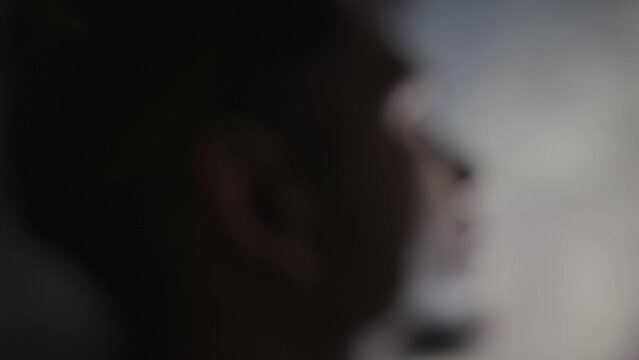 Silhouette of man in a dark room immersed in out of body religious experience