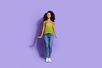 Full length photo of gorgeous young girl posing look up empty space wear trendy green sequins outfit isolated on purple color background