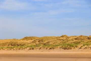 The beach in the Dutch city of Bergen on a sunny day with a blue sky