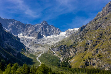 Obraz premium Chamonix Montblanc beautiful alpine mountain summits landscape. Alps mountains with snow and glacier above green valley of Chamonix in France. Alps beautiful scenery in summer