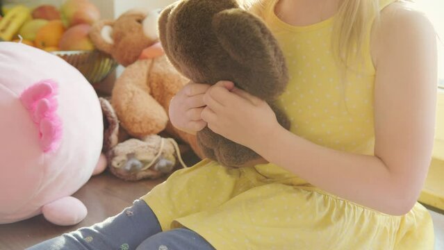 Adorable blonde preschool girl lovingly cuddles and plays with soft plush toy, cherishing first childhood companions, first childhood friends, creativity and storytelling skills, Innocence and joy