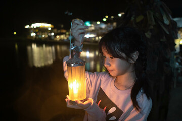 my Daughter with a lamp Night view at Pilok, Kanchanaburi Ban E-Tong in Pilok Thailand