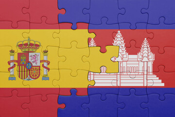 puzzle with the colourful national flag of cambodia and flag of spain.
