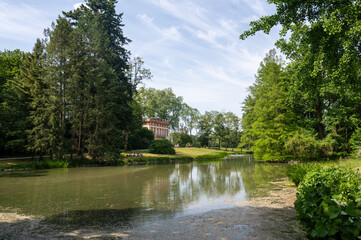A lake in green nature and with an old historical building