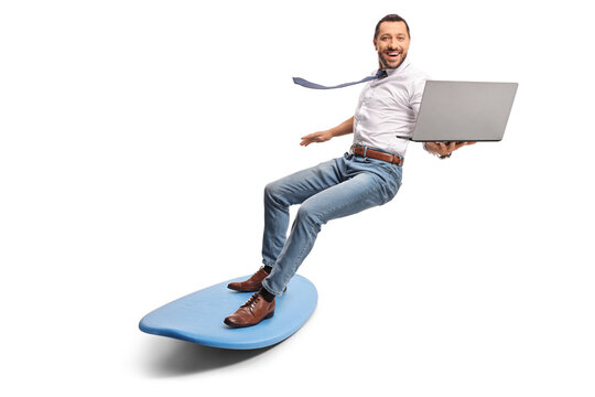 Man holding a laptop computer and riding a surfboard - Powered by Adobe