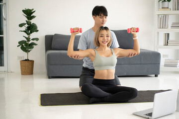 Smiling couple exercising together at home