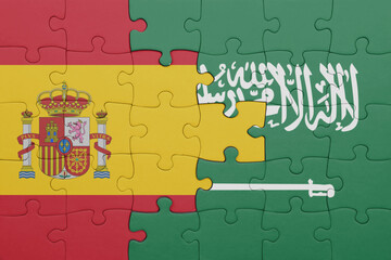puzzle with the colourful national flag of saudi arabia and flag of spain.