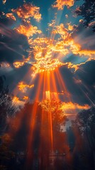 Obraz premium Dramatic sunset with vibrant colors and sunrays breaking through clouds, casting beautiful light over a serene landscape.