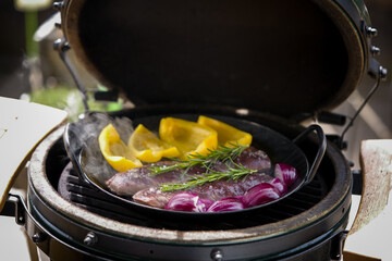 grilled tenderloin from roe's meat with yellow paprika, red onions and rosemary from a charcoal...