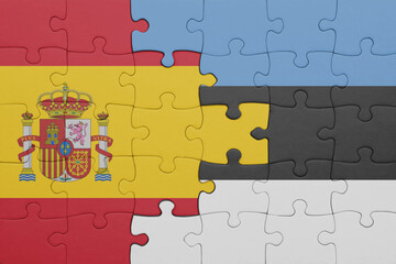 puzzle with the colourful national flag of estonia and flag of spain.