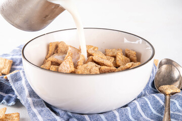 Cinnamon toast crunch mix in portioned bowl with milk. Sweet Trendy Crunchy Cinnamon Breakfast Cereal 