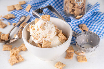 Cinnamon Toast Crunch ice cream with cinnamon sugar and caramel, small portion bowl with a lot of cinnamon toast cereal mix 