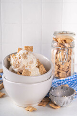Cinnamon Toast Crunch ice cream with cinnamon sugar and caramel, small portion bowl with a lot of cinnamon toast cereal mix 