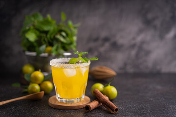 Fresh summer orange mojito with tangerine orange, mint and ice on black background