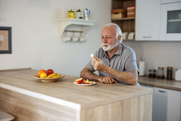 Portrait of a senior man eating an apple