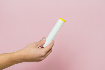 Hand holding bottle for pills, effervescent tablets or vitamin