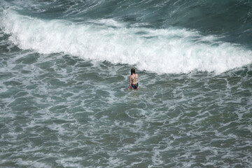 View of a woman in the surf, enjoying swimming