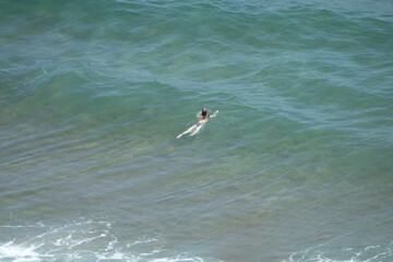 View of a woman in the surf, enjoying swimming