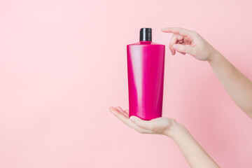 Cosmetic unbranded bottle for shampoo, mask, lotion in hands. Concept of beauty. Product cosmetic...