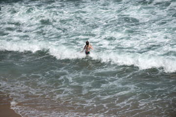 View of a woman in the surf, enjoying swimming