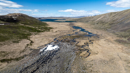 stunning landscapes of mountains, lakes and rivers from a drone flight in the southern regions of...