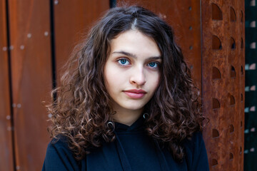 White teenager with curly hair and the most beautiful natural lips. Young girl face.